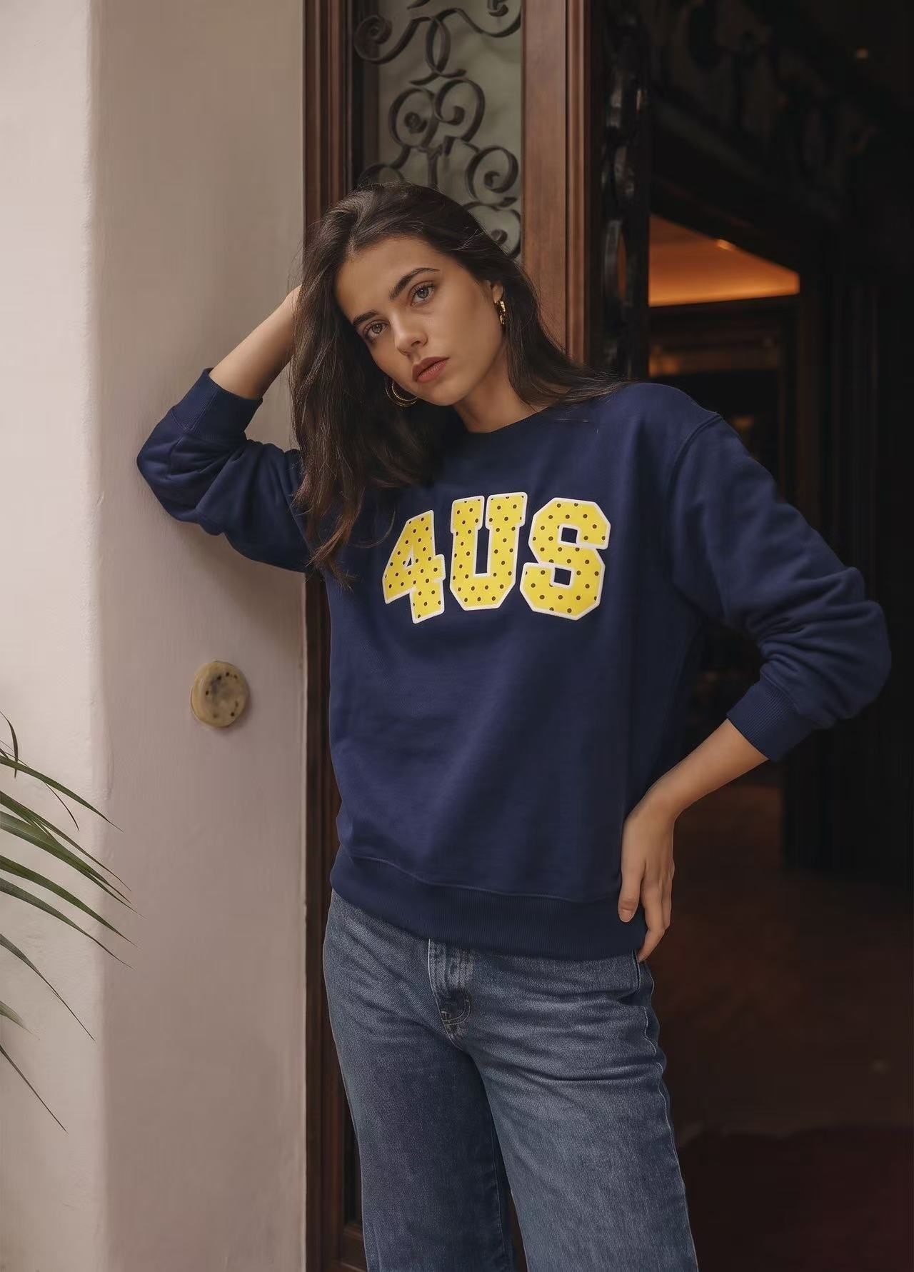 Navy printed sweatshirt on a model in an indoor close crop