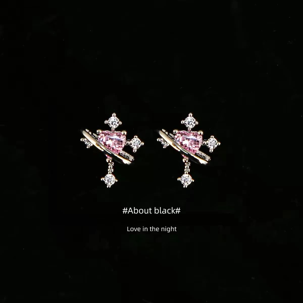 Pink heart-stone stud earrings on a black background