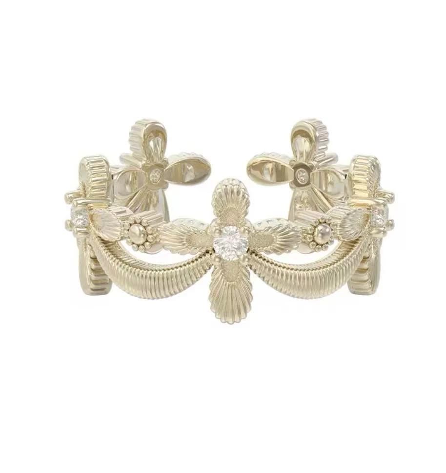 Openwork gold ring with a raised floral band pattern