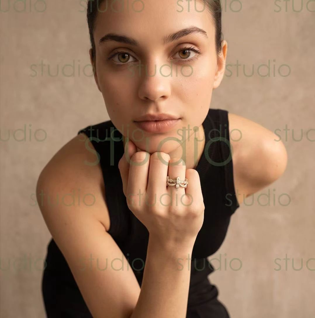 Studio Loya ring output with the model chin resting on a hand
