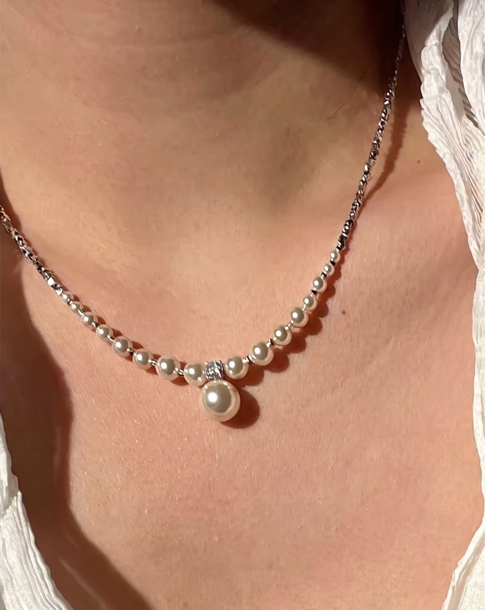 Generated model wearing the pearl drop necklace