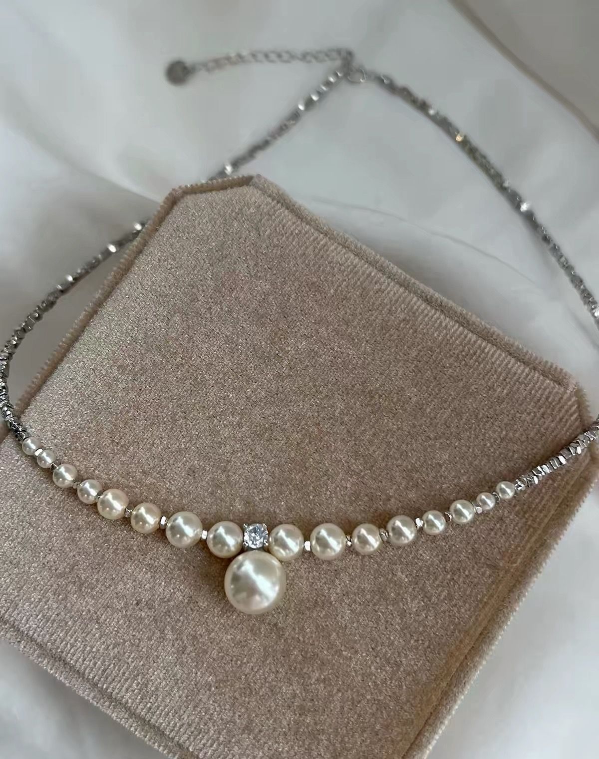 Pearl and silver necklace with a center stone and drop pendant