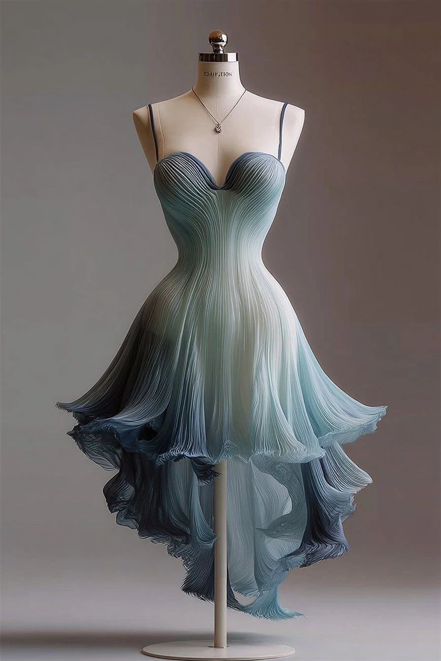 Blue ombré gown displayed on a dress form against a dark studio wall