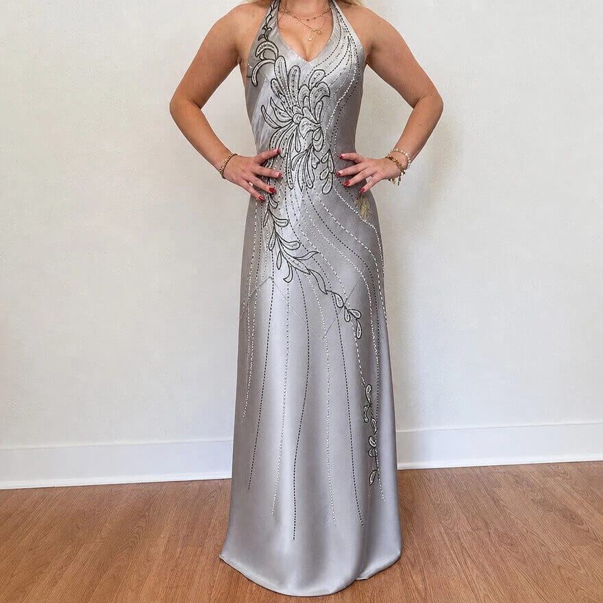 Silver satin dress with smoother fabric folds and sheen against a light background