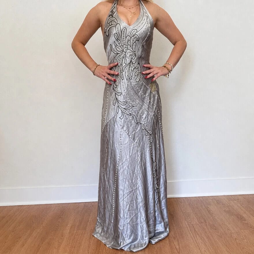 Silver satin dress with visible creases arranged against a light background