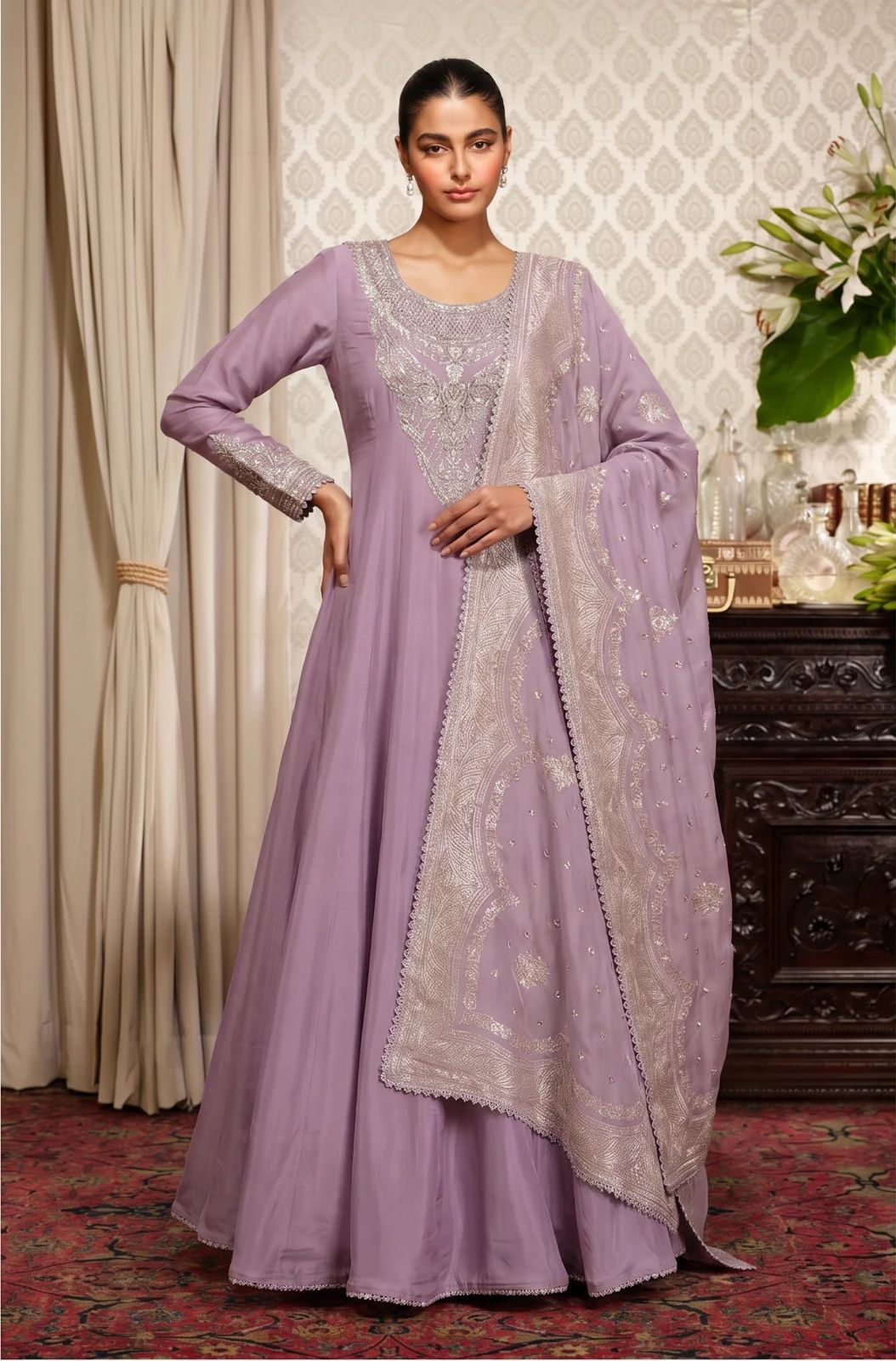 Model wearing a lavender Indian outfit with the dupatta draped over one shoulder