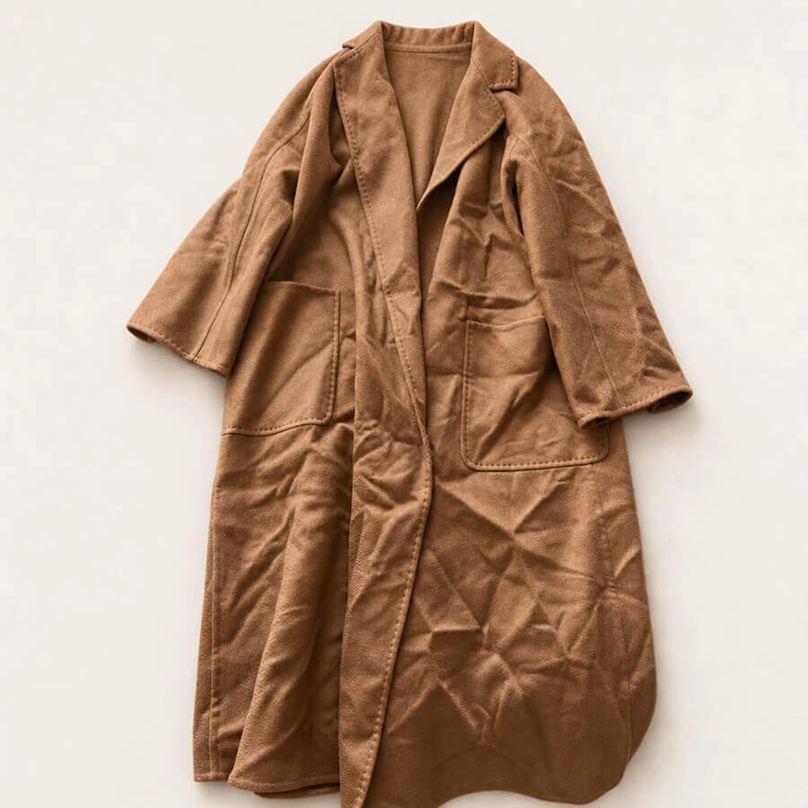 Brown coat with visible creases arranged on a plain background
