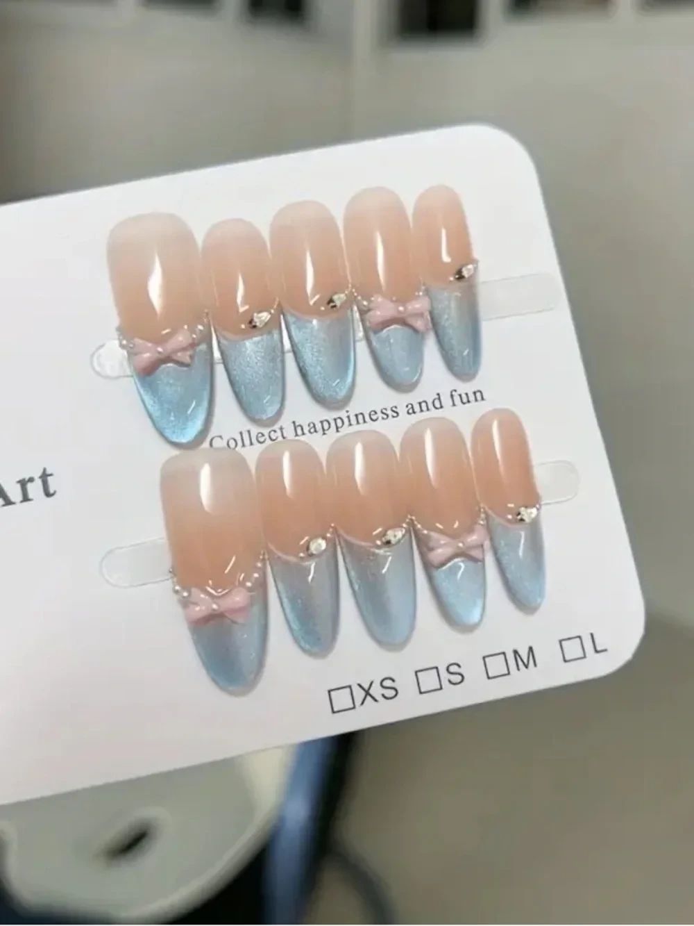 Set of nude press-on nails displayed in a plastic tray