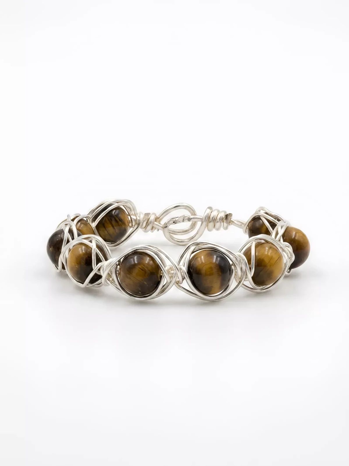 Gold ring with oval brown gemstones isolated against a clean white background