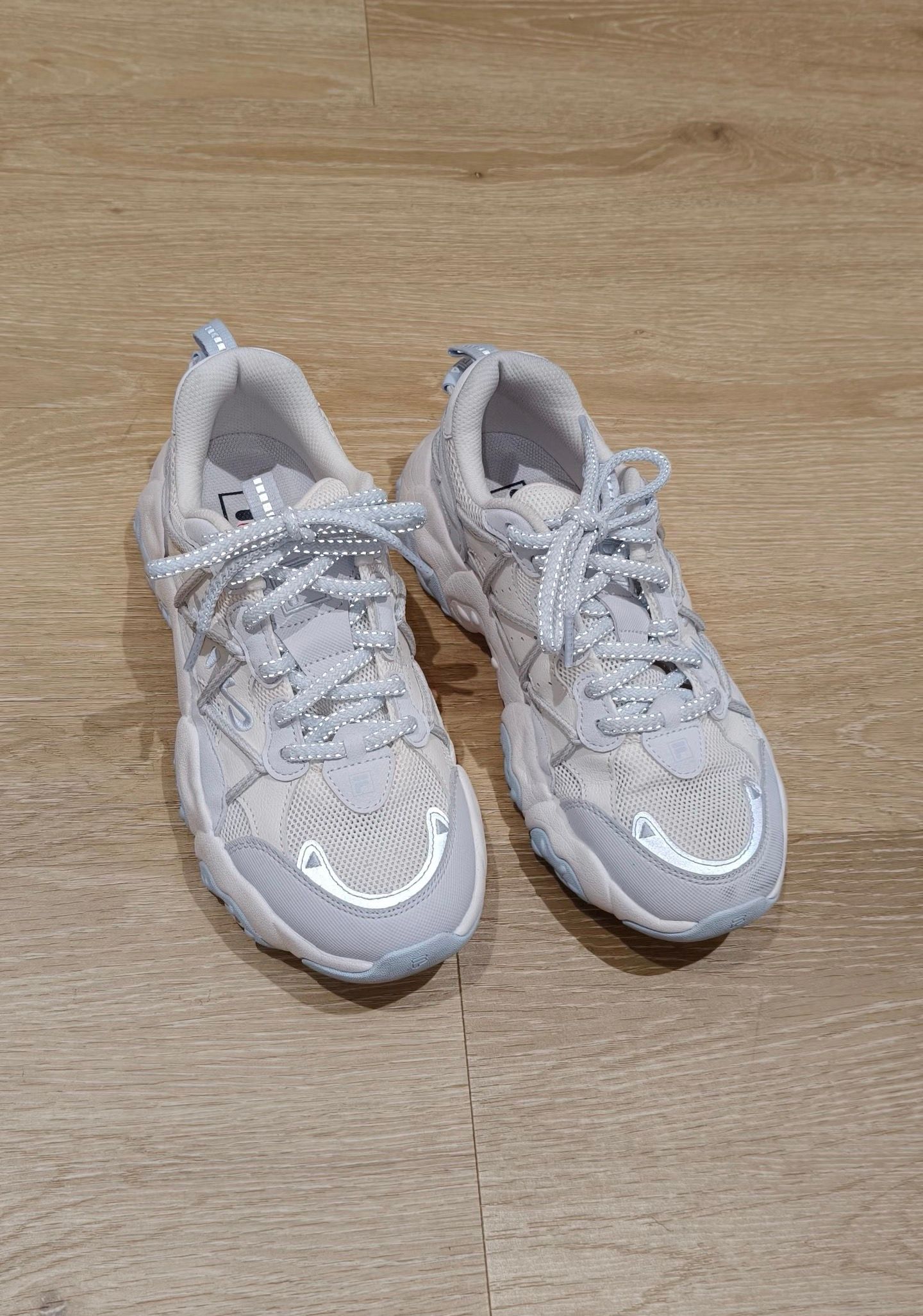 Original photo of a pair of grey sneakers