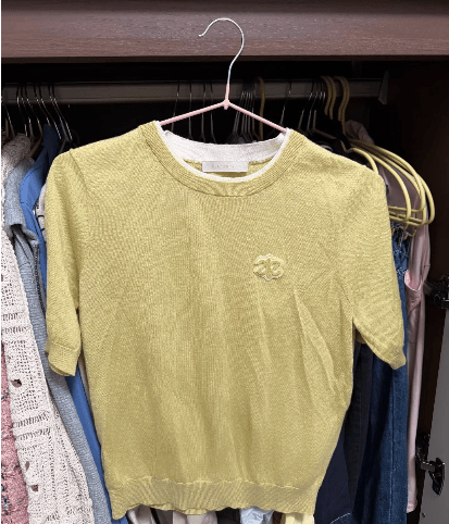 Yellow knit top with a chest motif after AirBrush wrinkle removal