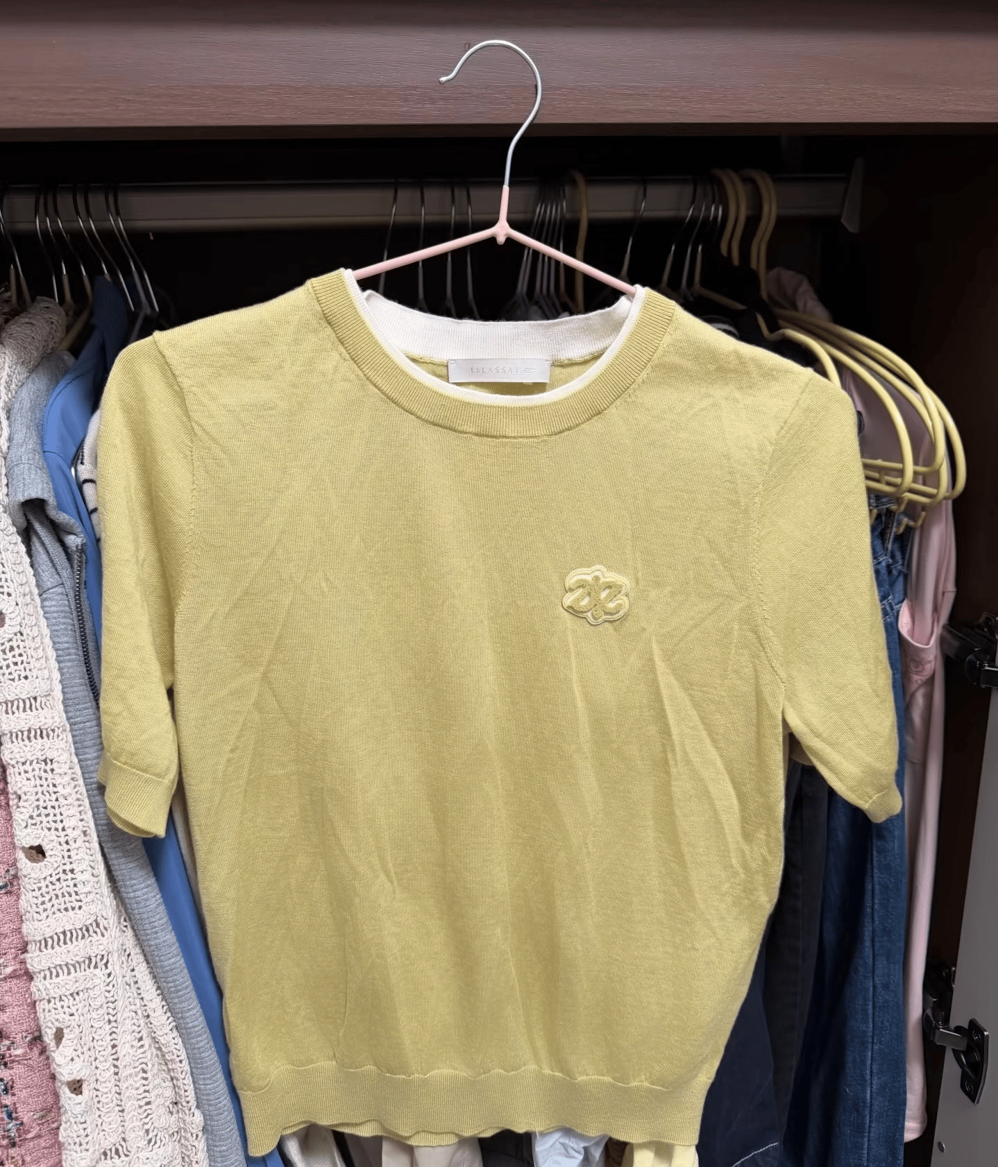 Yellow knit top with a chest motif after PicWish wrinkle removal
