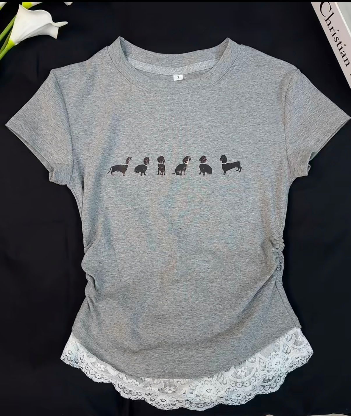Gray T-shirt styled as a flat lay on a dark surface