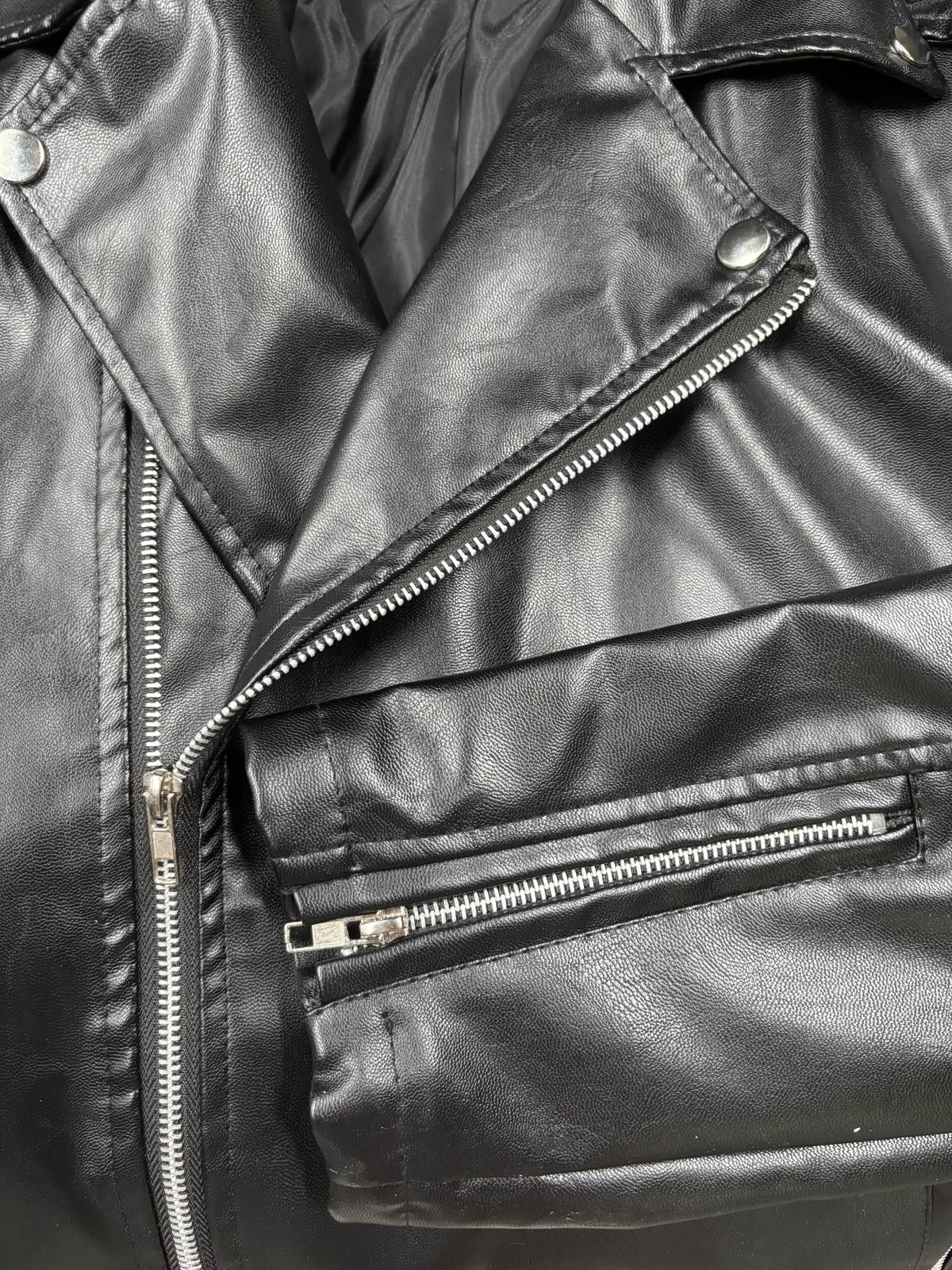 Close-up of the leather jacket zipper and construction