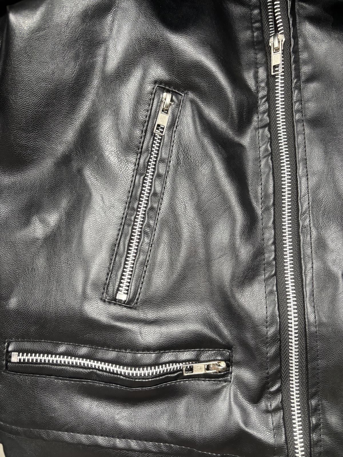 Close-up of the leather jacket pocket and zipper