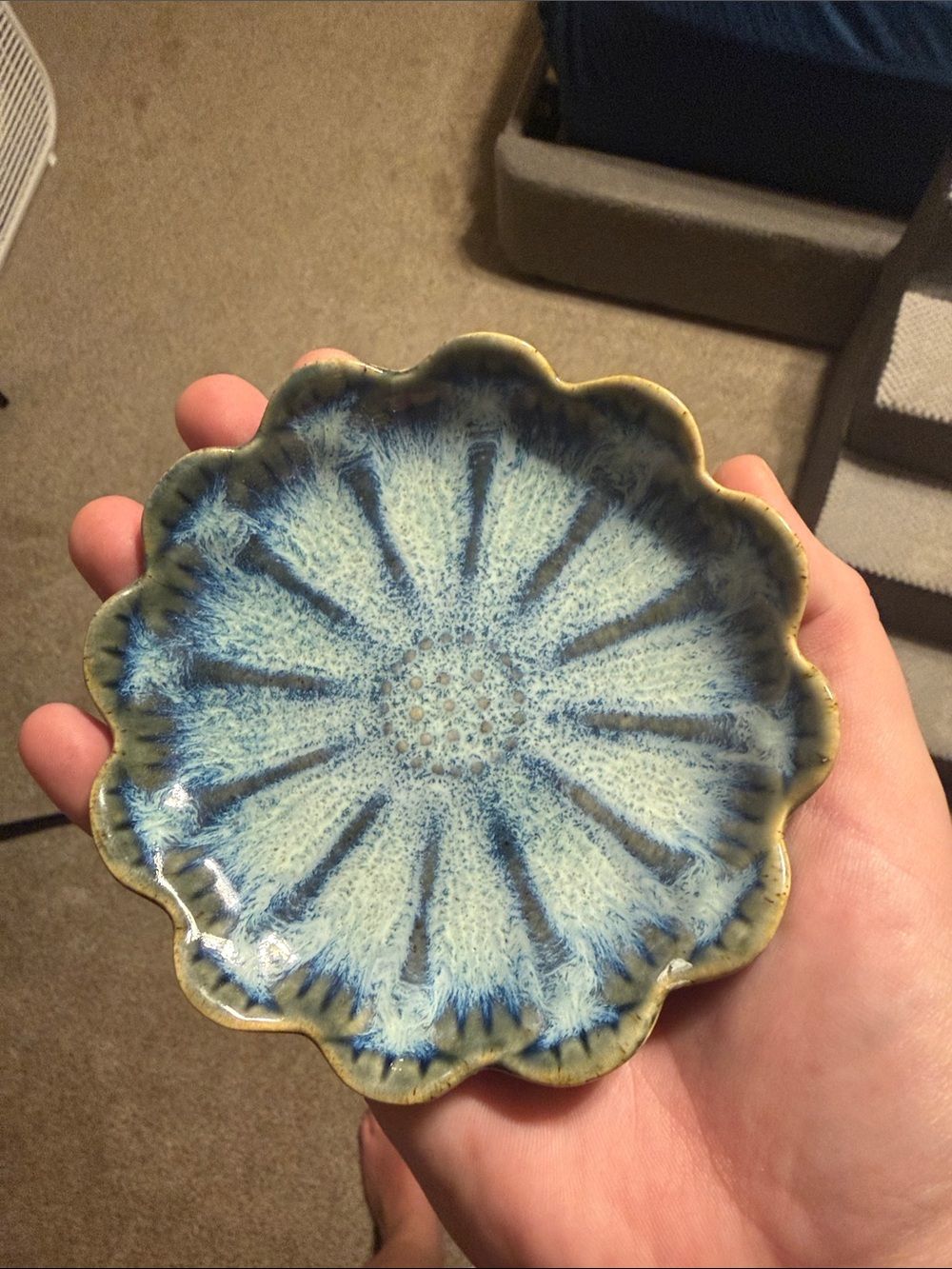 Original photo of a blue-green ceramic plate held in a hand