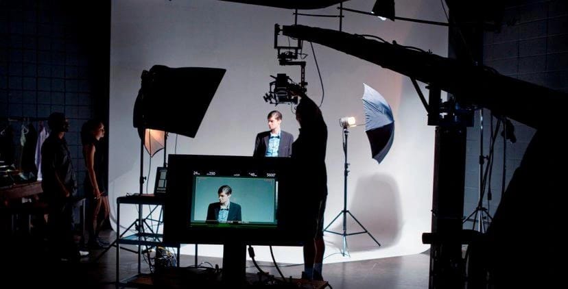 Model and camera crew in a studio with continuous lighting