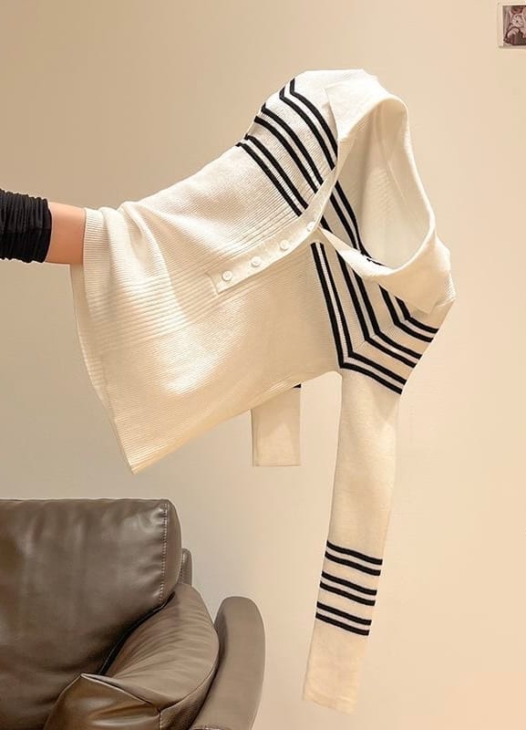 Striped cardigan held at an angle, with folds obscuring its natural outline
