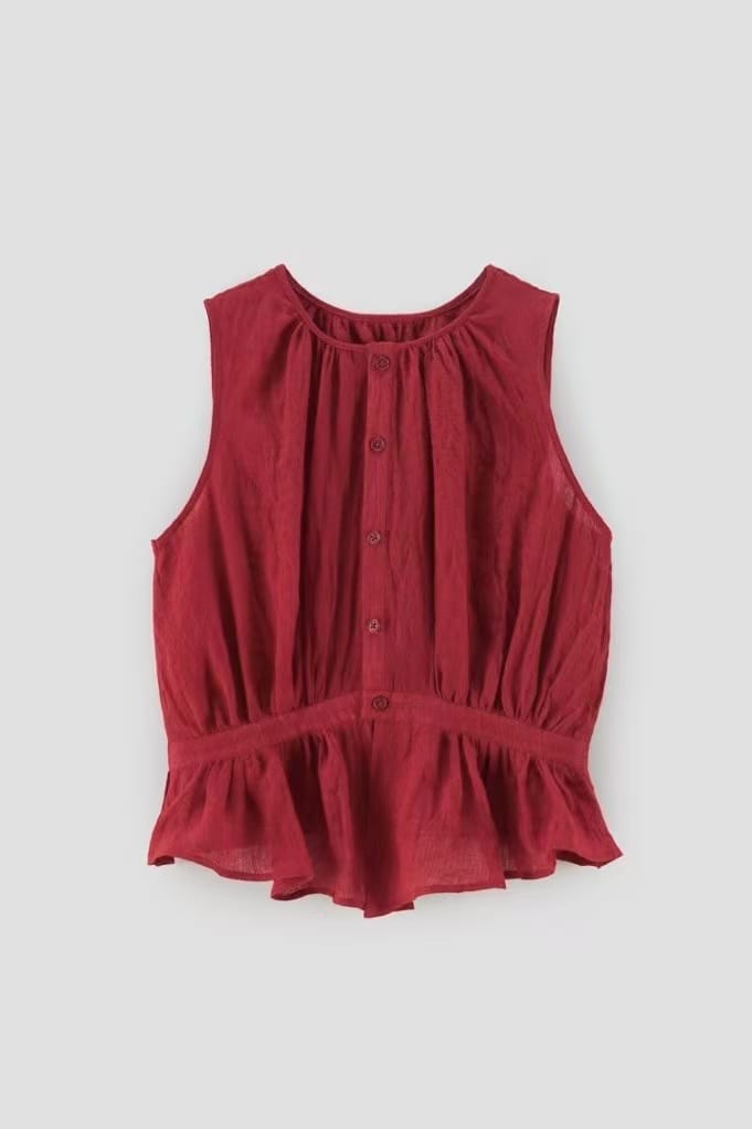 Same red top under cool-gray lighting