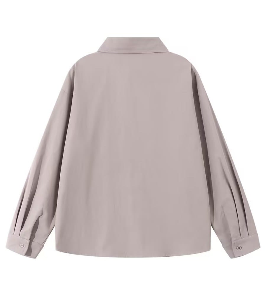 Back of the taupe shirt photographed flat on the same table