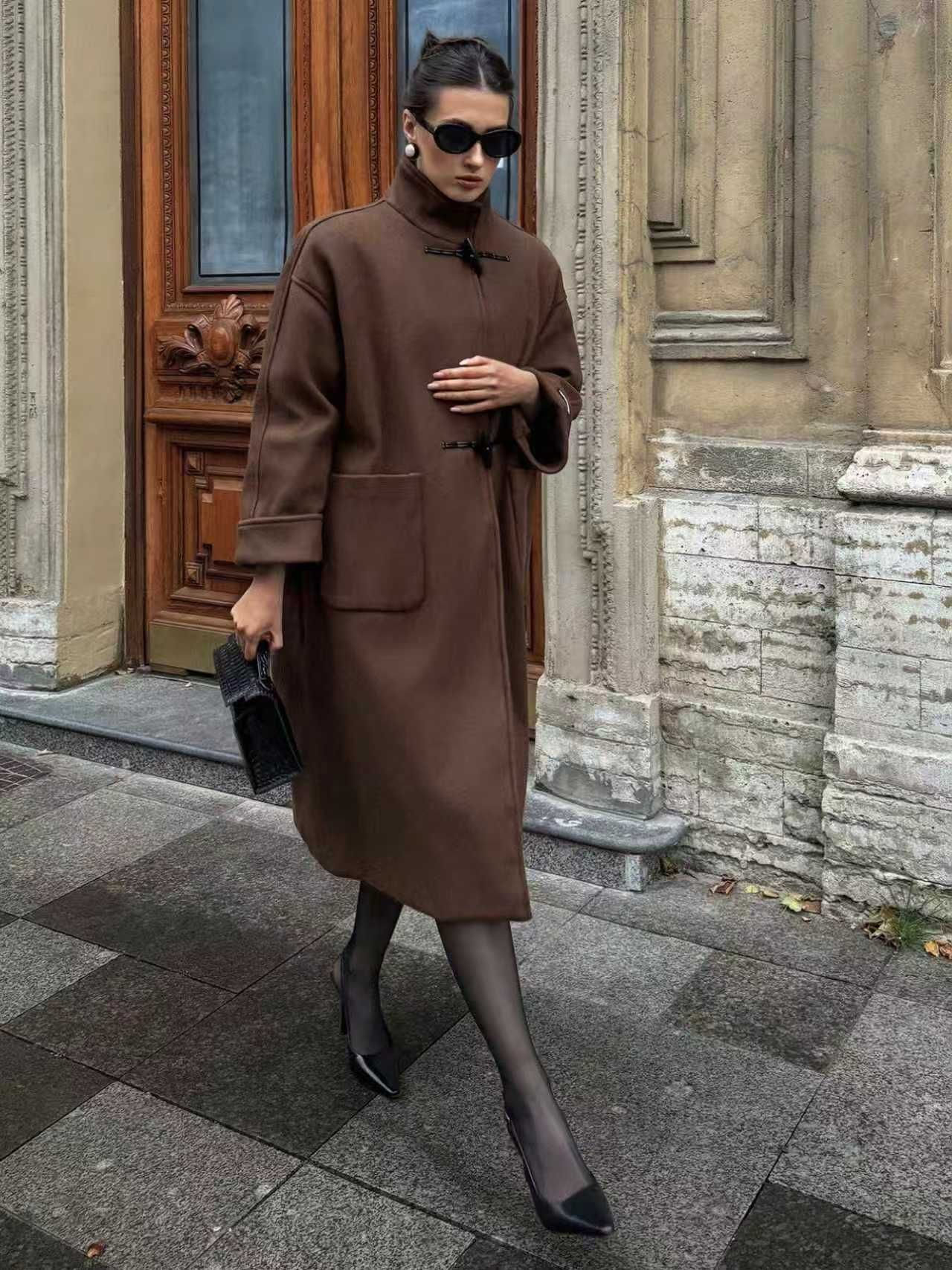 Outdoor lifestyle photo of a model wearing the same brown toggle coat