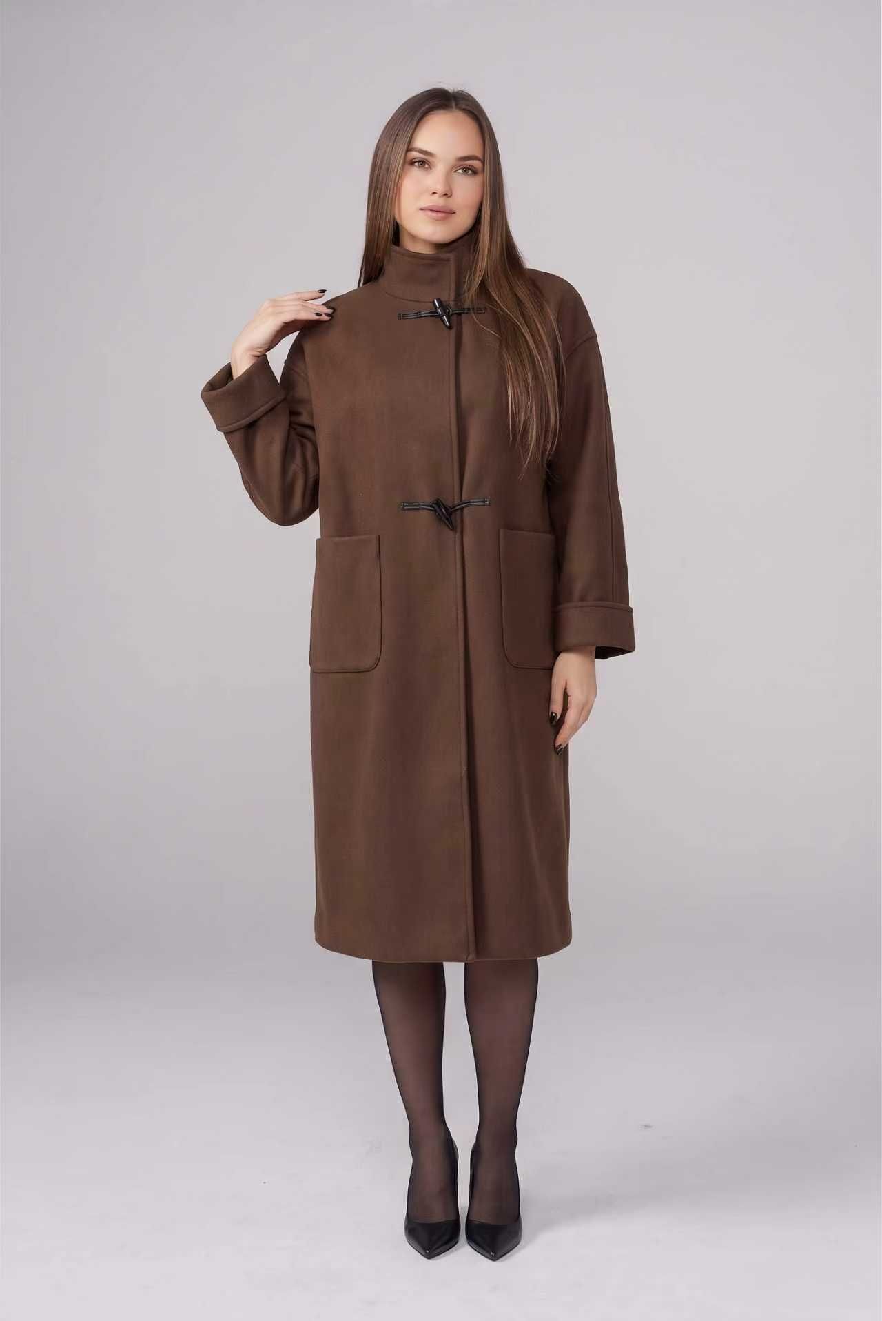 Full-length studio photo of a model wearing a brown toggle coat