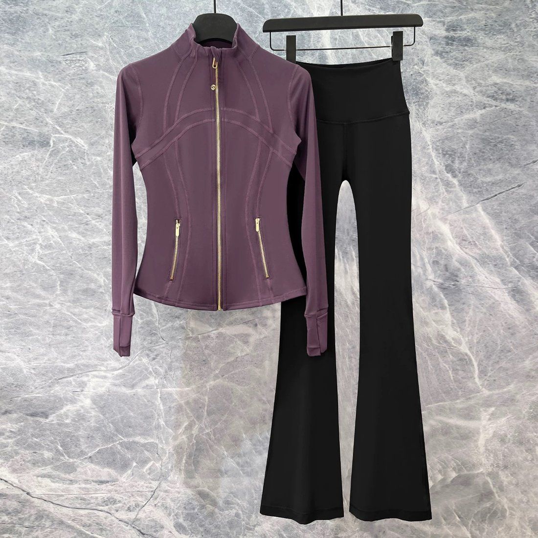 A purple athleisure set shown as a flat-lay product photo