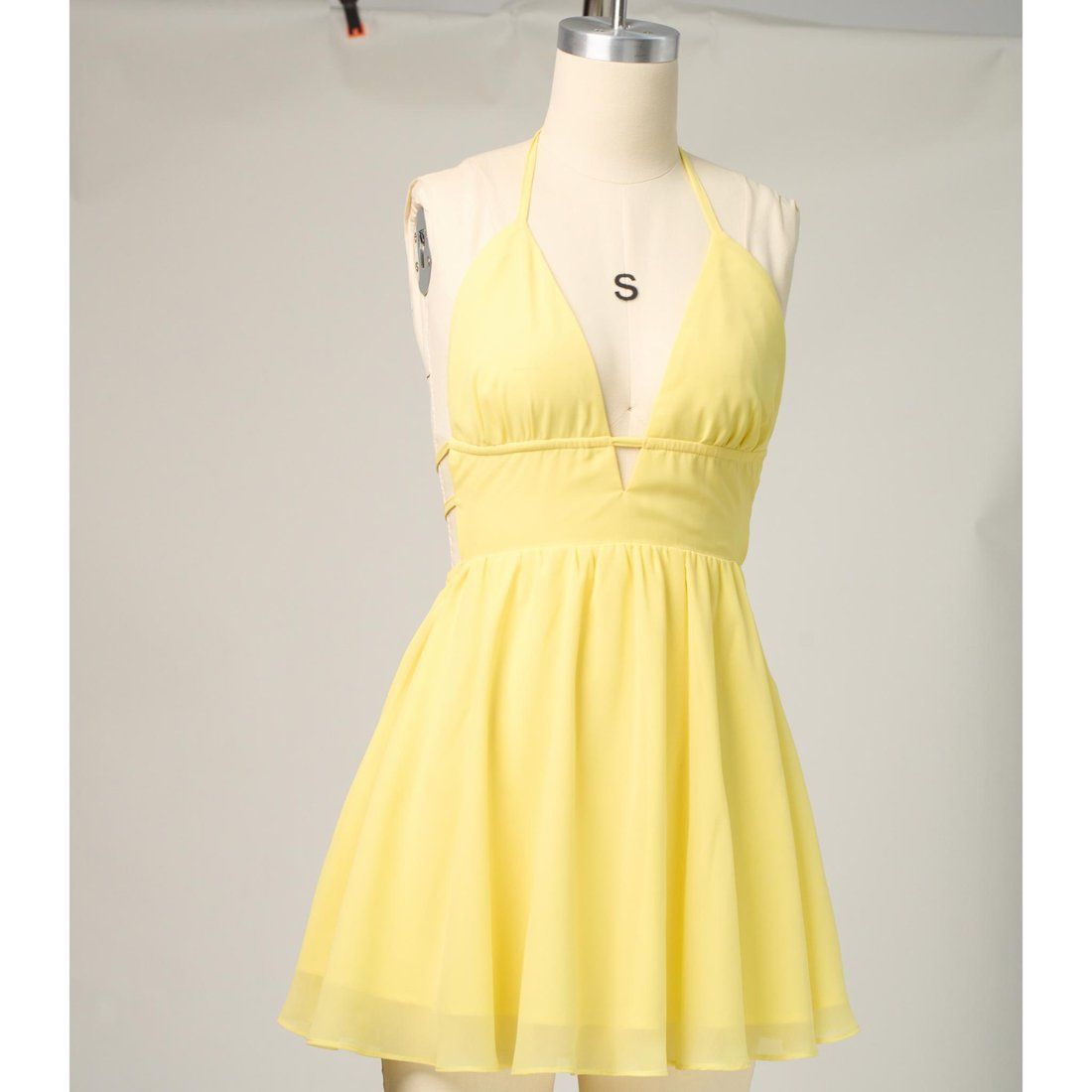 A yellow dress shown as a flat-lay product photo