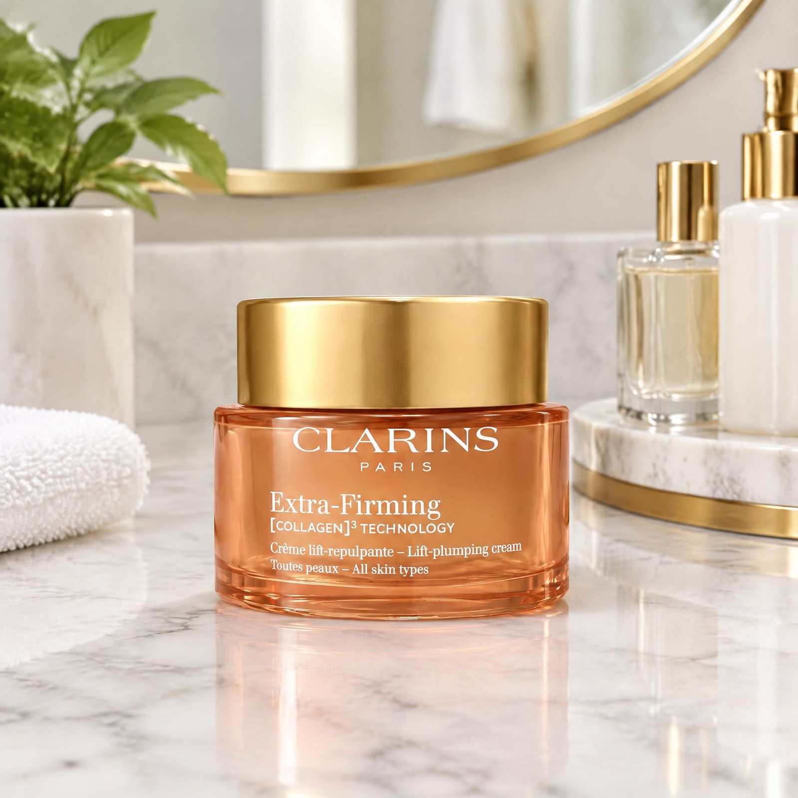 Closed orange cream jar on a marble bathroom counter with mirror and plant