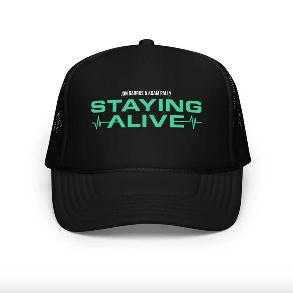 Print-on-demand baseball cap source photo — embroidered or printed design on a plain dad-cap or snapback against neutral studio backdrop, before AI lifestyle scene generation