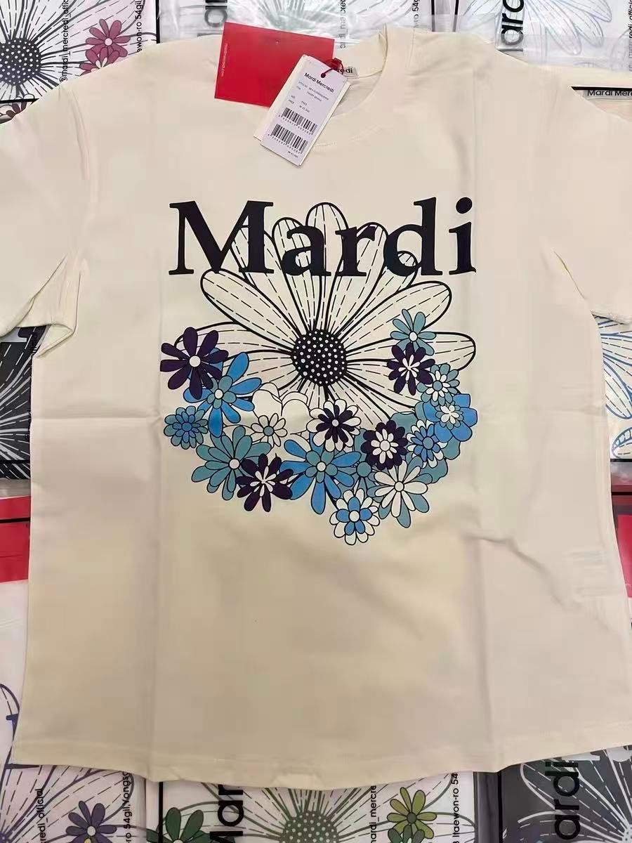 Source photo — cream Mardi Mercredi graphic tee shot on a phone with the hangtag still attached, used as the input for every tool tested