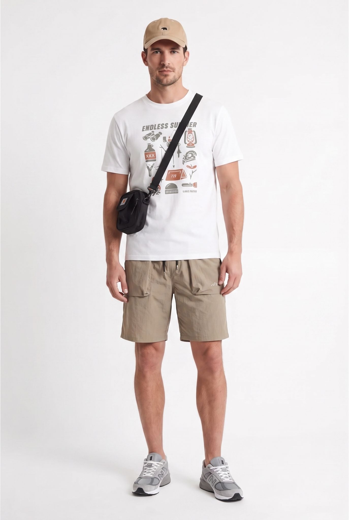 Snappyit result showing a male model in the printed white T-shirt, khaki shorts, beige cap, black crossbody bag and gray sneakers