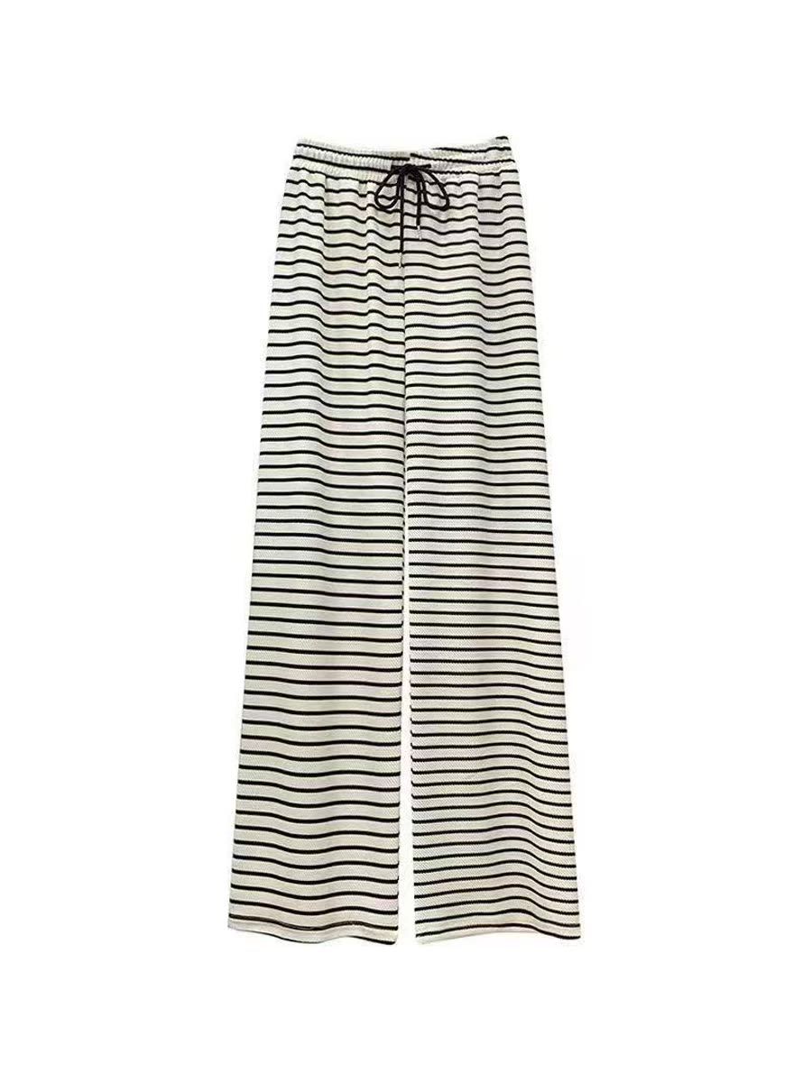 Cream wide-leg trousers with fine horizontal black stripes and a black drawstring, photographed flat on white