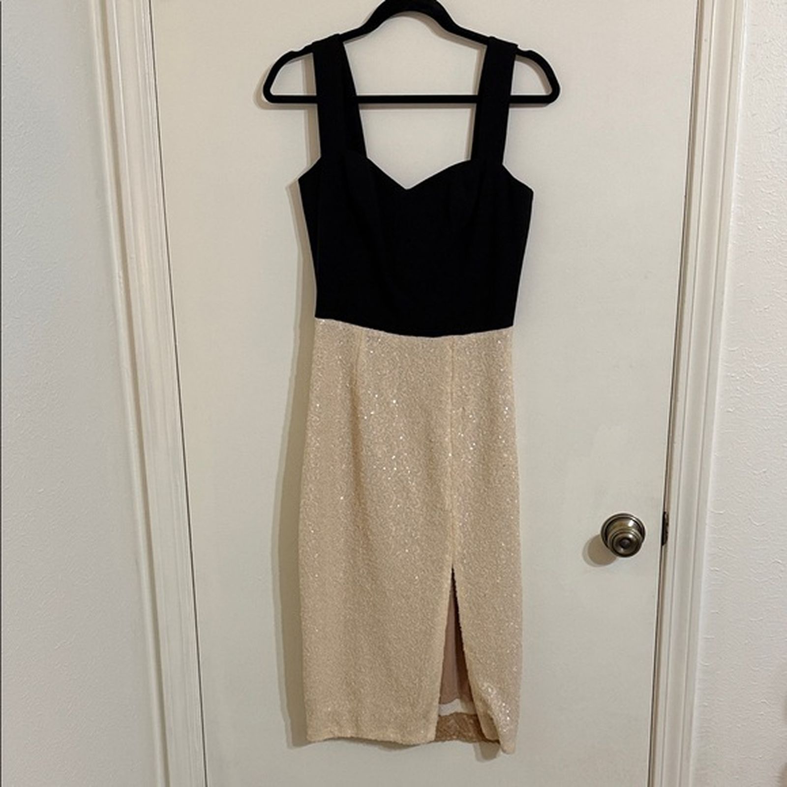 Black sequin dress photographed on a hanger as a reseller source image