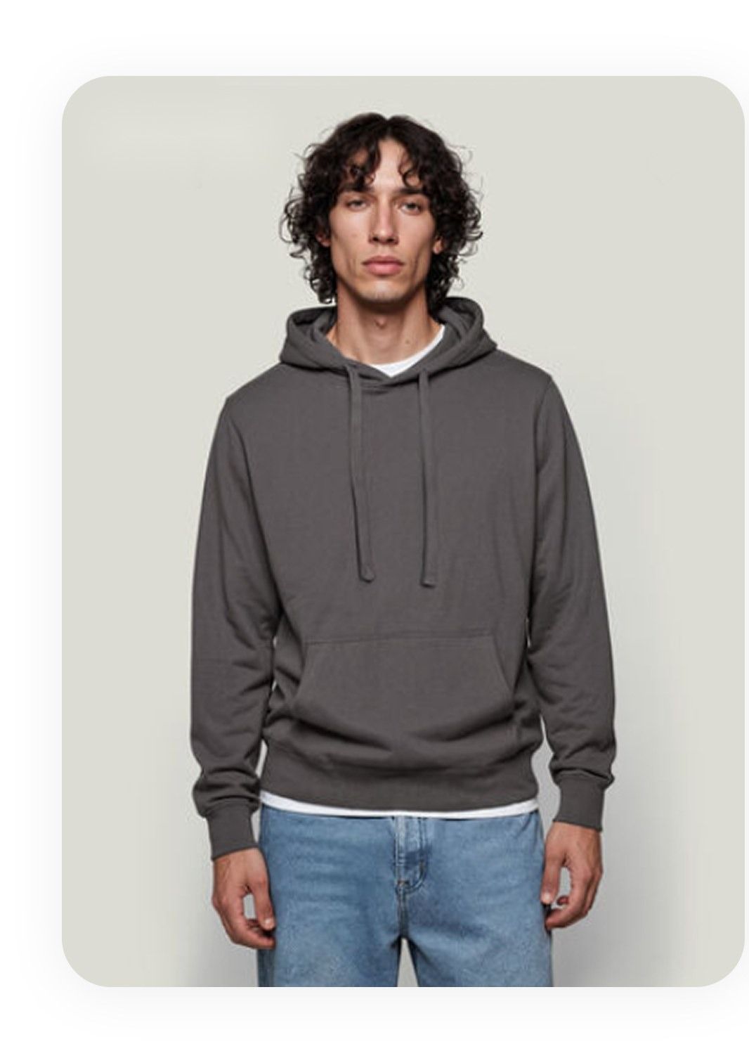 Thrifted gray hoodie photographed on a person against a plain wall