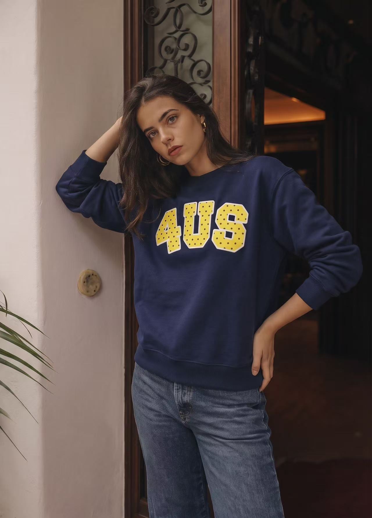 Navy printed sweatshirt on a model in an indoor close crop