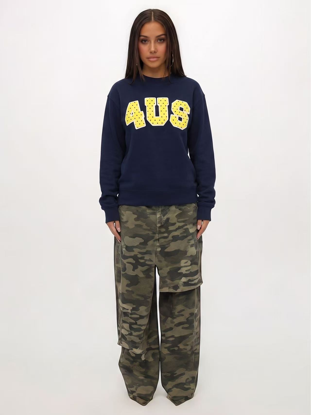 Navy printed sweatshirt on a model in a plain studio full-length image