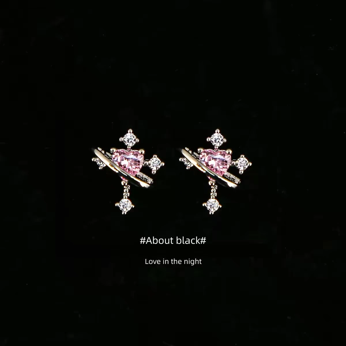 Pink heart-stone stud earrings on a black background