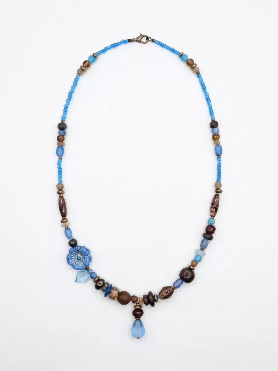 First AI attempt on the beaded necklace — flower bead repainted with different petals and the neighboring bead sequence changed