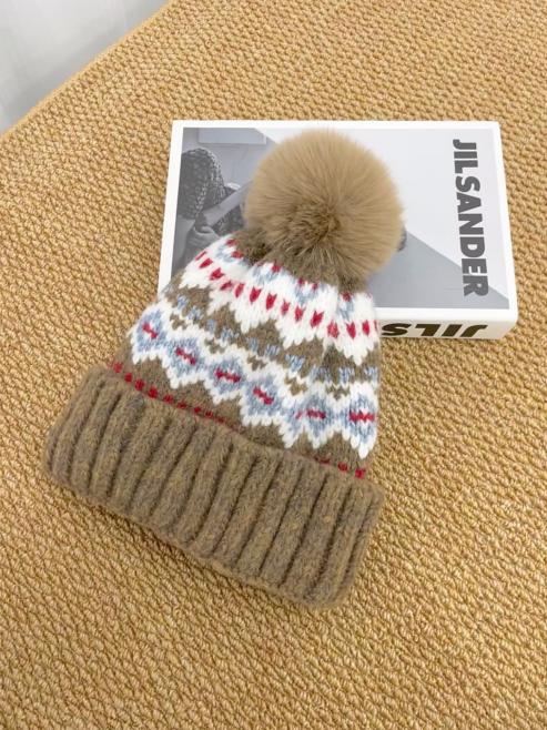 Flat-lay source photo of a knitted pom-pom beanie shot on a table