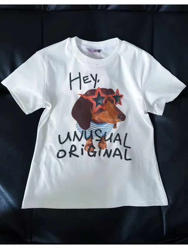 Printed T-shirt source on a black sofa