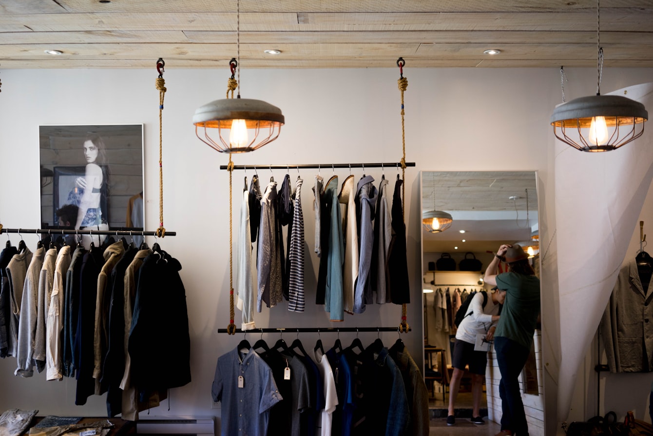 An apparel catalog begins as a rack of garments waiting to be photographed for an online store