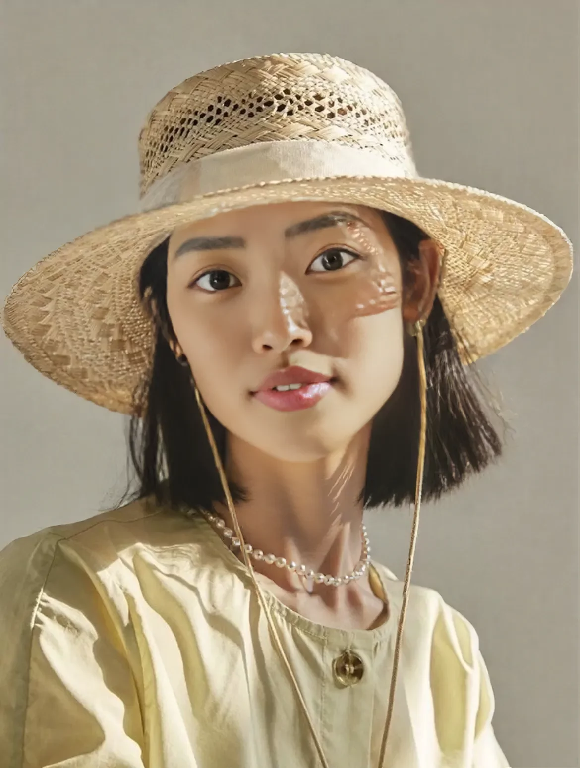 onmodel result on the straw hat portrait using the sumiko preset model with visible artefacts around the necklace