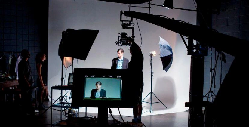Model and camera crew in a studio with continuous lighting