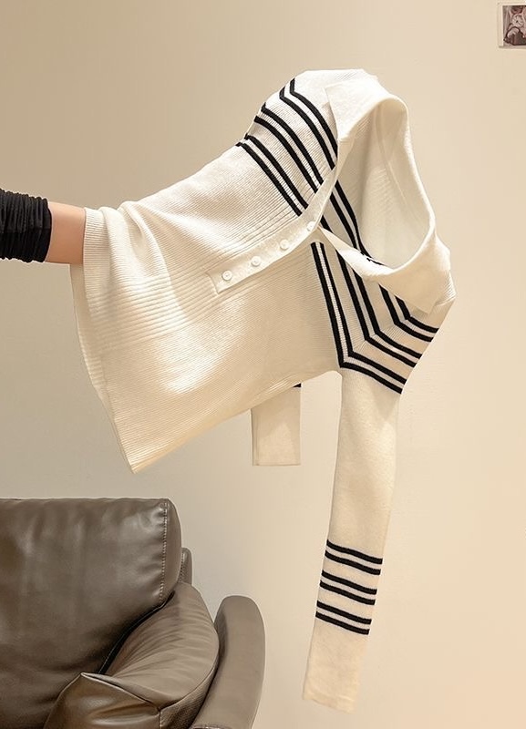 Striped cardigan held at an angle, with folds obscuring its natural outline