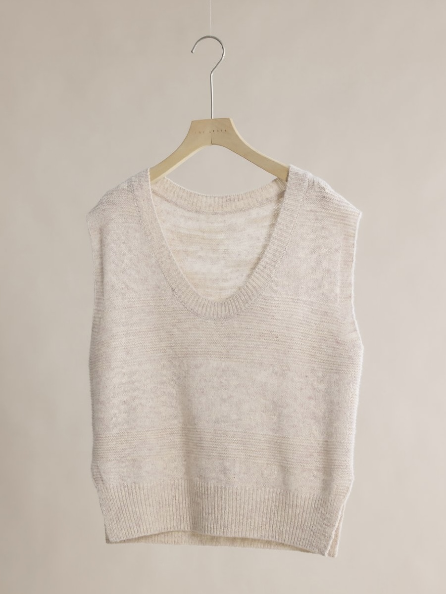 Original hanger photo of a light beige V-neck knit vest
