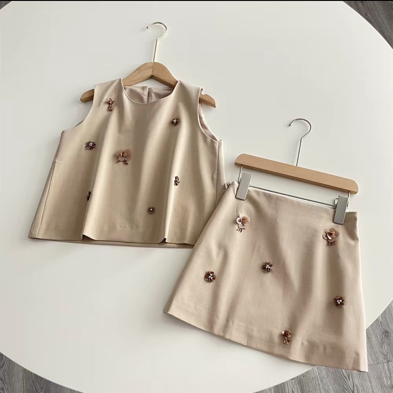 Original beige clothing set photographed on hangers before ghost mannequin processing
