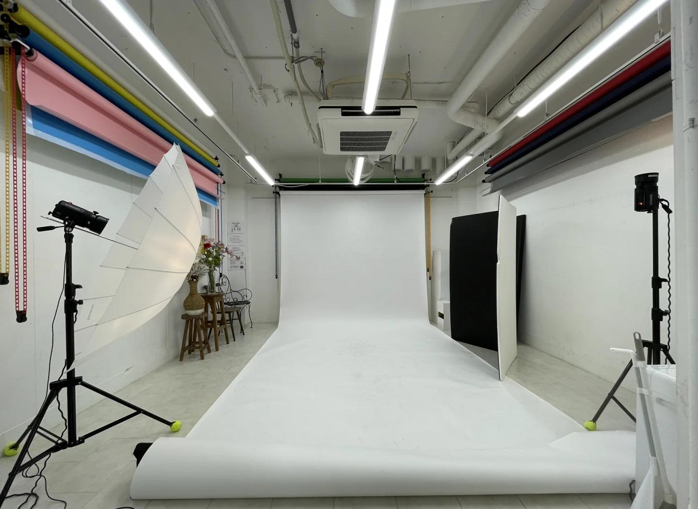 Product photography studio with a white backdrop and two-light setup