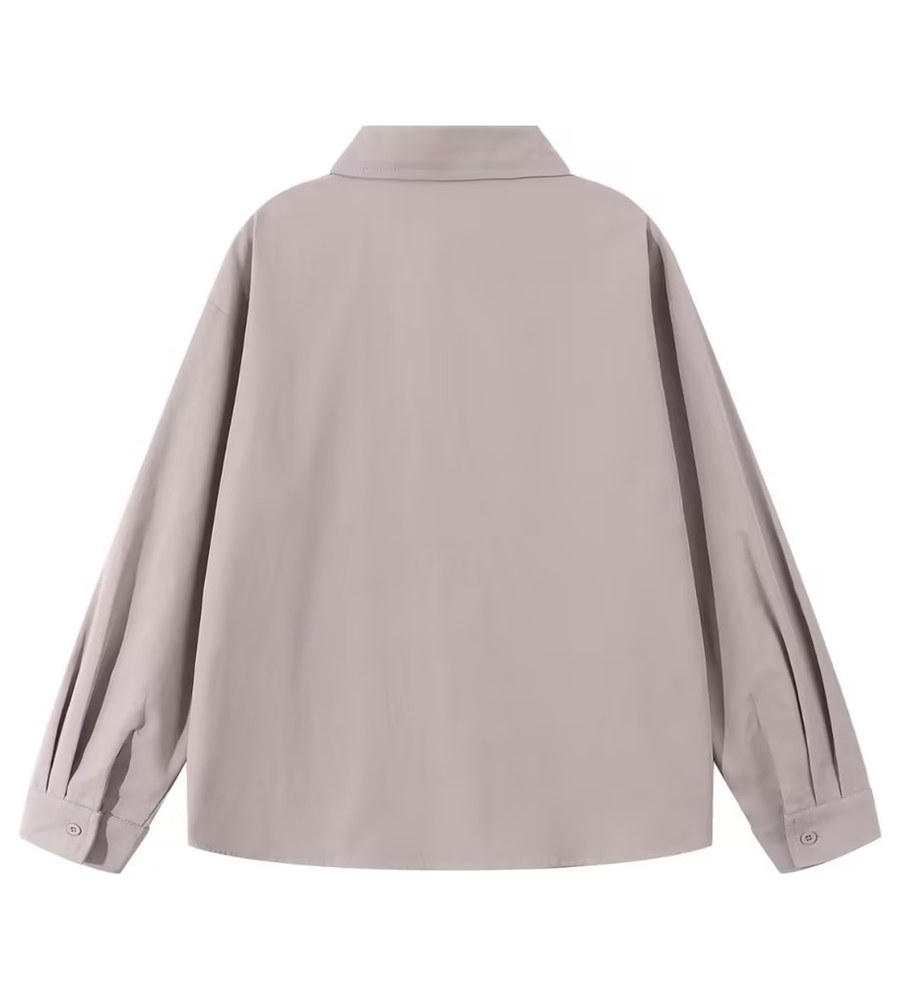Back of the taupe shirt photographed flat on the same table