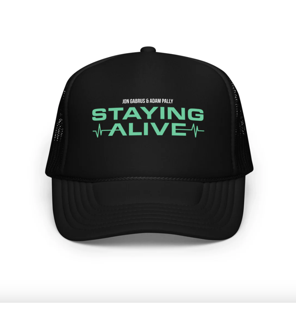 flat-lay product photo of a black trucker cap on a white background — the single source image you upload